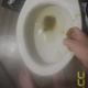 Emi is so constipated she needs a bath to get it moving. She squats in the tub in a red top and pushes, then holds up her turd over the toilet and shows the bowl. Vertical format video. About 3.5 minutes.